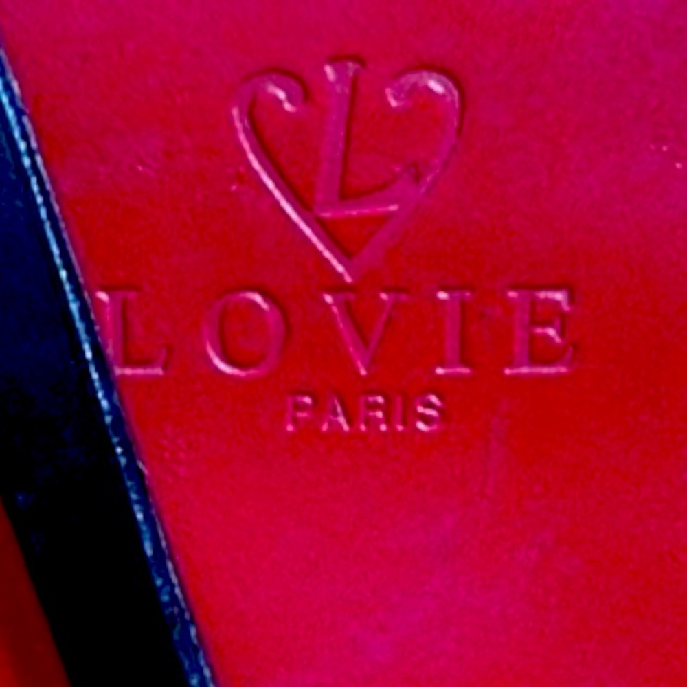 Lovie Paris red leather purse with black straps and black decorative bow.
